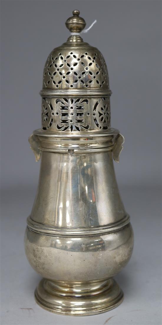 A silver lighthouse sugar sifter